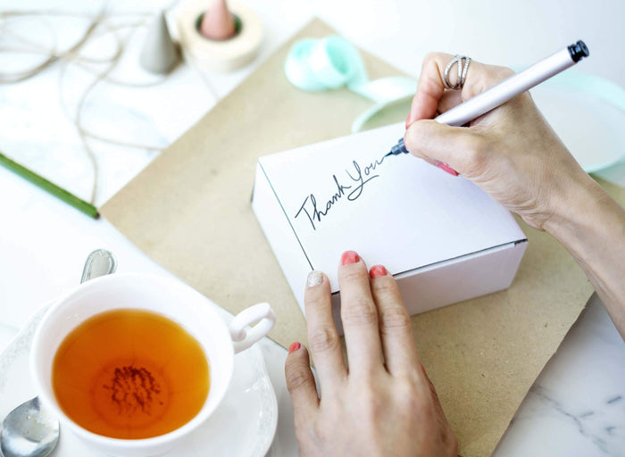 women signing thank you notes